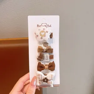 Vue détaillée d'un ensemble de pinces à cheveux à carreaux mignonnes pour filles avec nœuds.