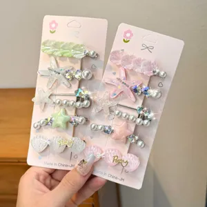 Closeup of cute star shell hair clips set with pearls and rhinestones on cards, perfect details.