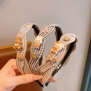 Cute checkered headband with lovely resin bear and rabbit charms, detail close-up view.
