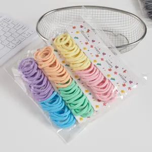 Seamless elastic hair ties detail shot, colorful scrunchies set on display card.
