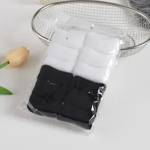 Nahtlose Frottee-Haargummis Nahaufnahme, Schwarz-Weiß-Packung im klaren Beutel.