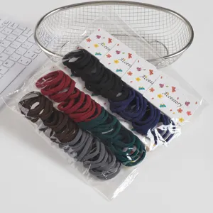 Seamless elastic hair ties in assorted colors with decorative backing cards, detailed view.
