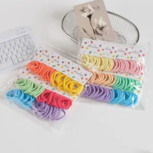 Detail view of colorful seamless hair ties in transparent bags, elastic and soft daily hair bands.