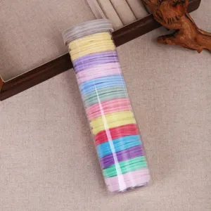 Colorful hair ties set in a clear plastic storage tube, high elastic rubber bands for daily styling.