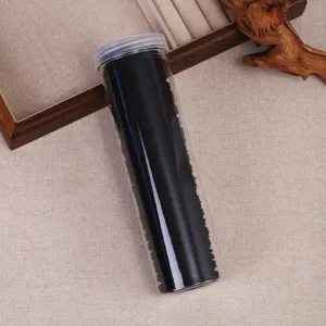Black elastic hair ties in a clear plastic tube container, ideal for daily hairstyles and ponytails.
