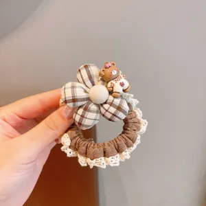 Sweet plaid hair scrunchie with cute flower and bear charm detail, perfect for sweet daily styles.