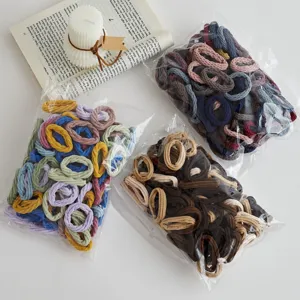 Colorful elastic hair ties in clear bags, soft stretchy scrunchies for daily hairstyles detail.