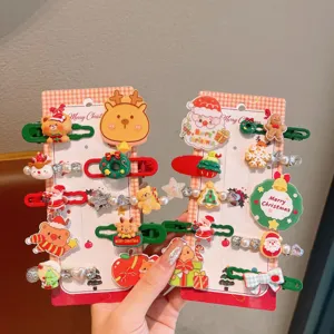 Detail shot of Christmas hair clips featuring cute cartoon Santa and reindeer on cards.