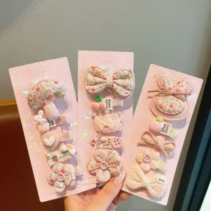 Cute cartoon hair clip set for girls, sweet pink fabric hairpins with floral and animal designs.