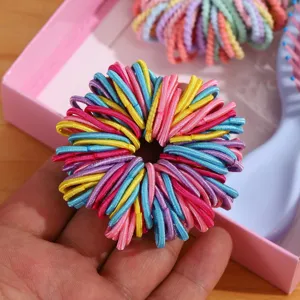 Colorful elastic hair ties for kids, detailed close-up view of cute multicolored hair bands.