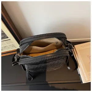 Black grid pattern crossbody bag with multi-compartments, casual commuter women's shoulder bag.