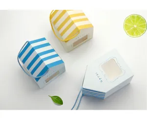 Close-up detail of house shaped gift box with striped roof and window design for baking.