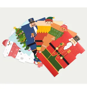 Detailed view of Christmas candy packaging boxes featuring cute festive cartoon character designs.