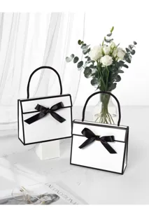 Minimalist black and white gift box with elegant bow detail for premium packaging.