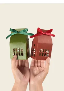 Christmas house gift box detail, hollow window design with ribbon bow, folding paper candy packaging.