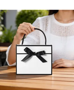 Minimalist black and white gift box with bow, elegant handle packaging bag for presents.