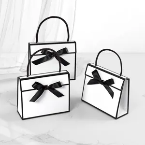 Black and white bow handbag gift box, folding paper gift packaging bag for party favors.