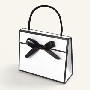Minimalist black and white gift bag with elegant bow, perfect for luxury packaging.