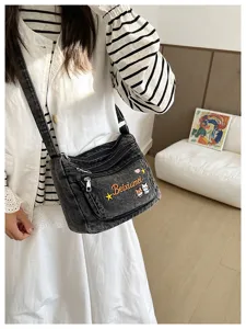 Casual denim crossbody bag with multi compartments and cute cat embroidery for daily wear.