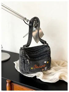 Cute multi-compartment denim crossbody bag with embroidery detail, versatile casual shoulder bag.
