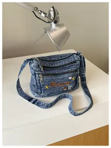 Casual denim crossbody bag with multi-layer zipper pockets and cute cat embroidery design.