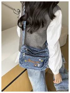 Fashion denim crossbody bag with multi compartments and cute cat embroidery for women daily use.