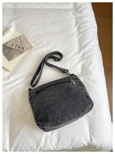 Casual dark grey denim crossbody bag with multi-compartments and adjustable strap.