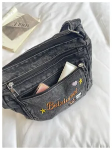 Denim crossbody bag with multi-compartments, cute embroidery, and secure zipper pockets.