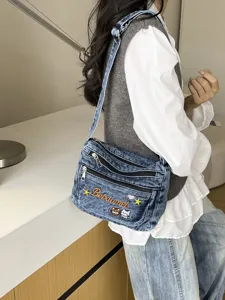 Stylish denim crossbody bag for women, multi-compartment design with cute embroidery.