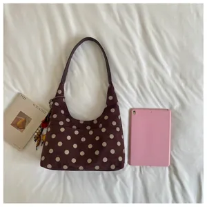 Chic polka dot suede shoulder bag with cute hanging pendant and convenient daily storage.