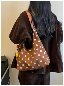 Brown suede hobo shoulder bag with white polka dots, soft texture and cute hanging charms.
