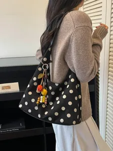 Casual polka dot shoulder bag for women, stylish hobo handbag with cute charms for daily use.