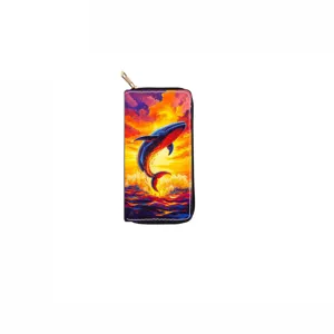 Close-up detail of long zippered wallet featuring vibrant whale and sunset ocean art print.