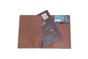 Brown Saffiano leather texture passport holder detail view with multiple card slots and cash pocket.