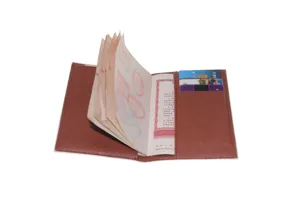 Brown Saffiano leather passport cover detail showing card slots and passport page insert.