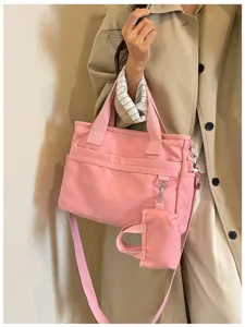 Vue détaillée du sac cabas en toile rose, sac décontracté avec sangle et mini pochette.