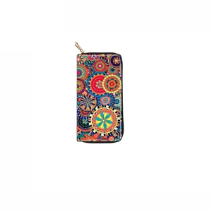Close-up detail of the vibrant ethnic mandala floral print on this long zip-around wallet.