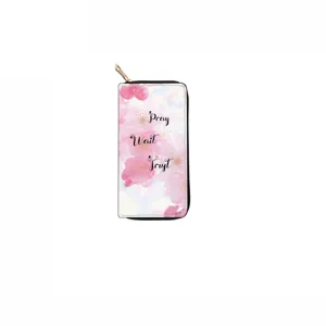 Close-up detail of the long zipper wallet featuring a pink floral pattern and inspirational quote.