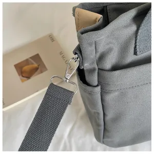 Sac bandoulière en toile grise pour femme, sac à main décontracté polyvalent avec sangle.