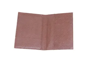 Detailed view of the textured PU leather passport holder featuring interior slots for cards.
