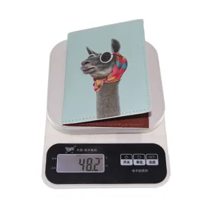 Detail view of a cute cartoon animal printed PU leather passport holder shown on scale.