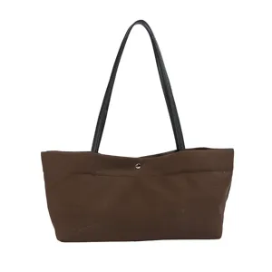 Casual brown canvas shoulder bag with black leather handles and snap closure for women.