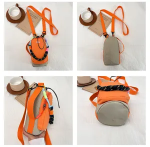 Detailed view of the orange colorblock outdoor phone and water bottle crossbody bag.