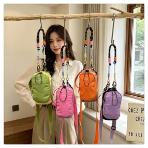 Stylish contrasting color mini crossbody bag and outdoor phone pouch with rope strap detail.