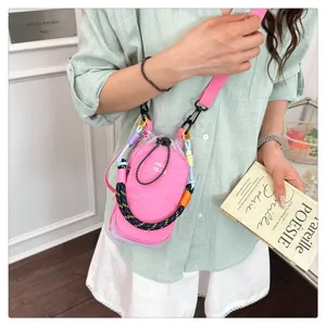 Detail shot showing the stylish contrast color multi-functional outdoor phone bag worn by model.