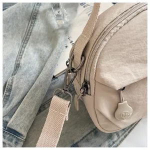 Minimalist nylon shell crossbody bag for women, lightweight casual shoulder phone bag daily use.