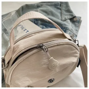Casual nylon round crossbody bag, lightweight casual shoulder bag with top handle and zipper.