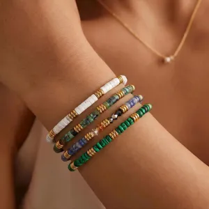 Stunning natural stone beaded bracelet stack featuring colorful gemstone and chic gold spacers.