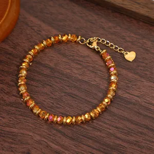 Elegant gold crystal beaded bracelet with extension chain and heart charm for women fashion.
