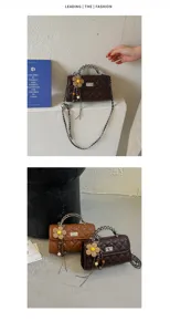 Details of the vintage quilted shoulder crossbody bag with chain strap and cute flower charm.